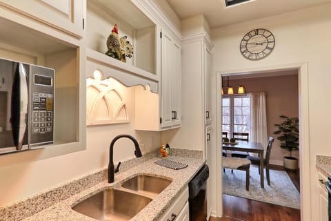 Microwave and double sink in kitchen.