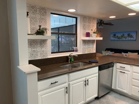 Sink side of kitchen leading into the family room.