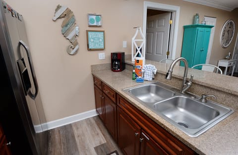 Paper towels, dish towels, sponge, and two dishwasher pods are provided.