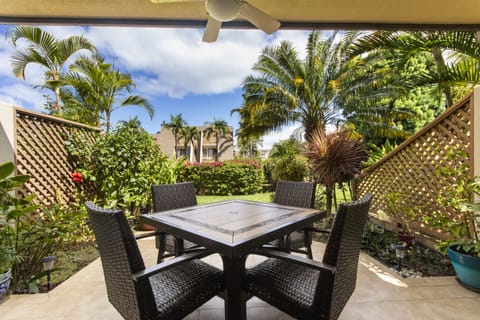 Your private patio offers a peaceful garden oasis with tropical palms swaying overhead—perfect for morning coffee or sunset cocktails surrounded by lush greenery.