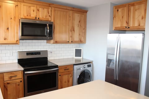 Cute kitchen has all amenities - fridge, stove, dishwasher, microwave