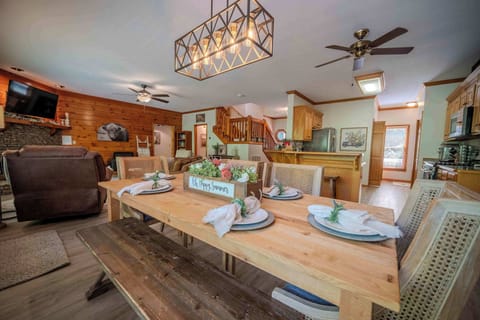 The heart of the home features a spacious dining area and fully equipped kitchen with bar seating—perfect for family meals, holiday feasts, or lazy morning breakfasts. With large windows that bring in the natural light and charming touches throughout
