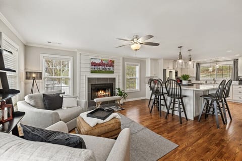 Step into our open-concept second living space + large kitchen with a fireplace, large smart TV, and tons of natural light. This room is sure to be a favorite!