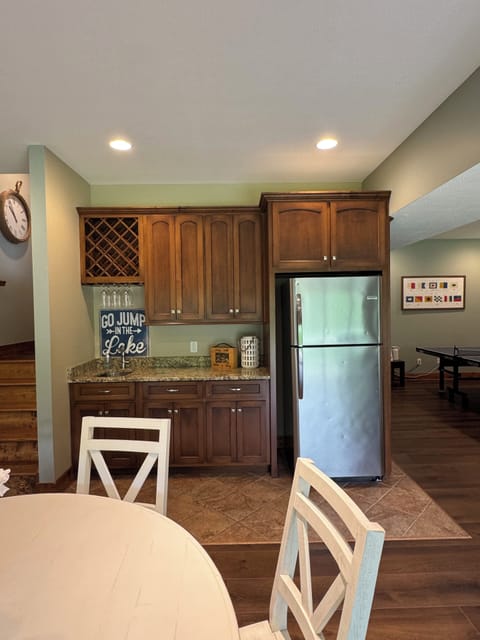 Full size refrigerator and sink in the basement