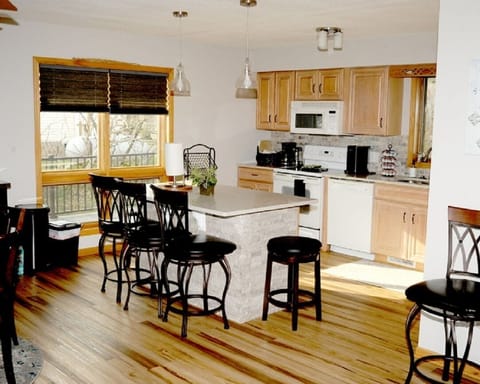 kitchen equipped with an island and dining room table equipped and fully stocked