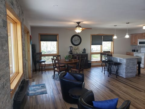 kitchen and dining room open to living room overlooking the lake