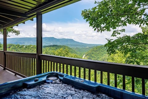 Take a soak in the hot tub on the huge front porch with amazing mountain views!