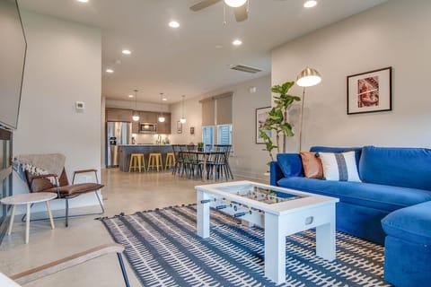 Enhance your living room experience with a large TV and Bluetooth sound bar, perfect for connecting your devices and enjoying music while you relax!
