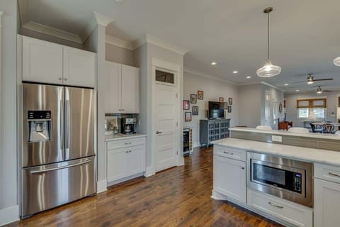 Modern appliances add a beautiful and efficient touch to this high-ceiling, open kitchen.