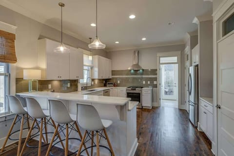 Clean lines and crisp whites define this kitchen, creating a serene sanctuary for all your culinary adventures.