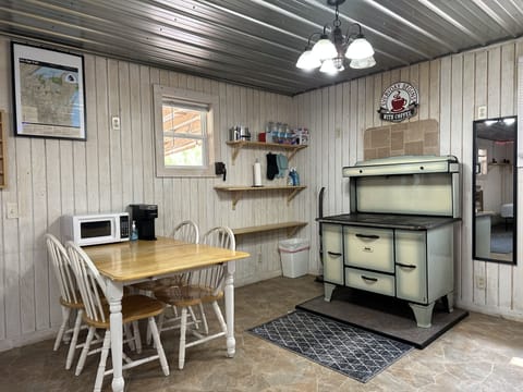 Pioneer stove decorative. Gas grill outdoors along with open fire w grill