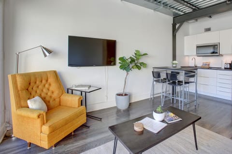 Living Room / Kitchen, featuring a laptop stand/ end table.
