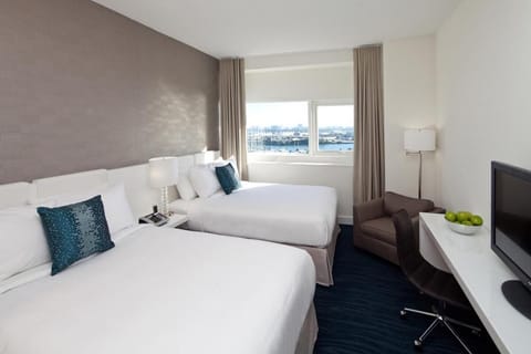 Unwind in crisp linens with soothing city-and-water views.