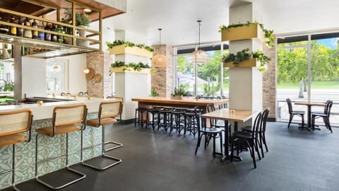 Gather for casual bites in a bright, garden-view dining space.