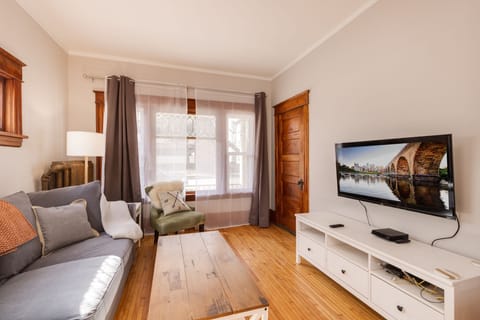 Living room with large windows, tv, sitting area. on main floor