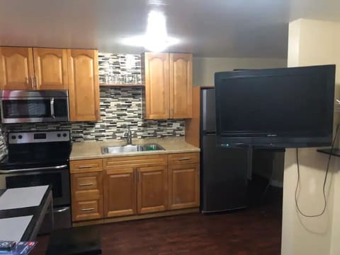 Common area with kitchen,  dining, pullout couch, and standing closet