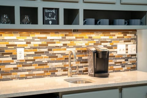 The wet bar is stocked with water, tea, and coffee.