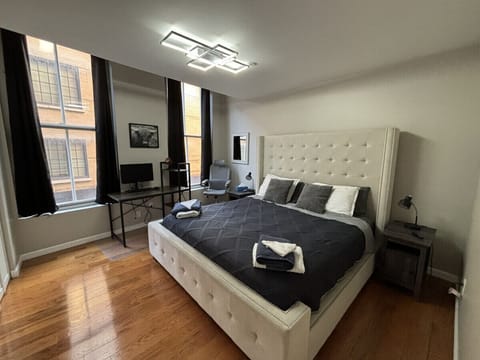 Bedroom # 1 - King bed + workstation and monitor. Bedroom very bright and sunny! Facing Maiden Lane. 7 ft windows!