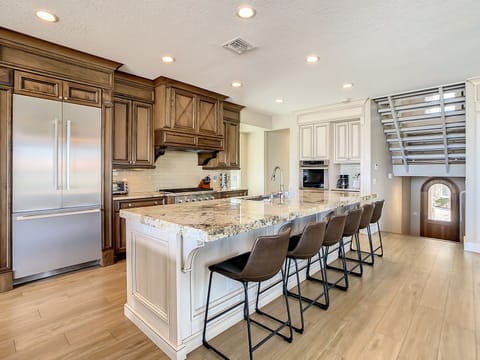Stainless appliances throughout the kitchen. Seating for 6 at the kitchen island.
