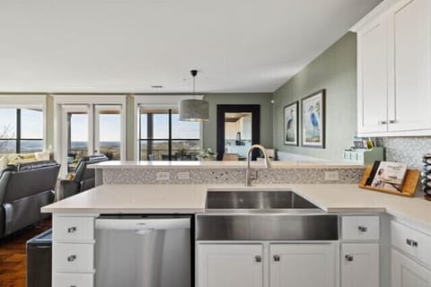 Kitchen with quartz countertops, Bosch dishwasher, and large stainless sink