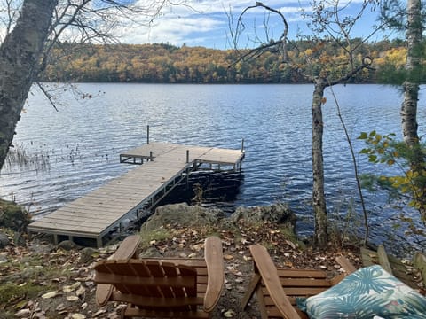 View from the dock of Long Pond, Maine in fall foliage colors