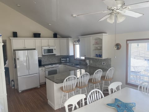 Kitchen has granite counter tops and the table is plenty big for family games