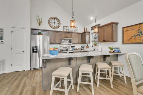 Our kitchen island is perfect for making meals, sitting and visiting and views !