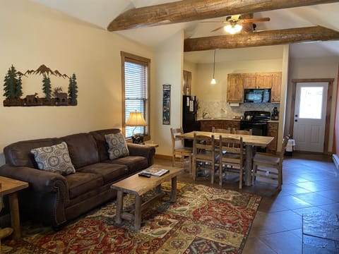 Living room with vaulted ceilings and log accents.