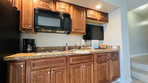 Kitchen: refrigerator with ice maker, stovetop, microwave, sink