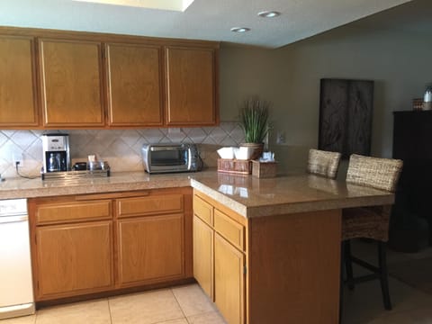 Coffee maker and toaster oven with lots of counter space.