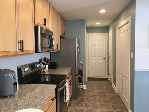 Kitchen/laundry/half-bath/pantry/door to garage