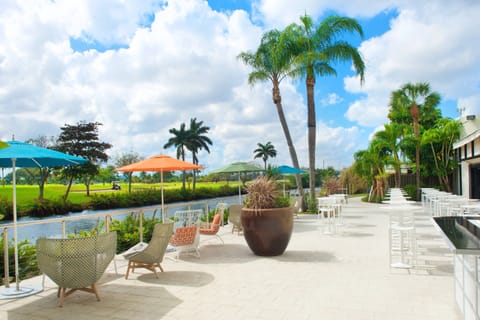 Unwind on the breezy patio with colorful umbrellas and views.