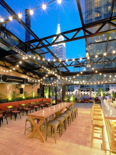 Toast the city lights under twinkling strings and glass.