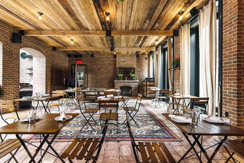 Sip craft cocktails beneath dramatic arches at the elegant bar.