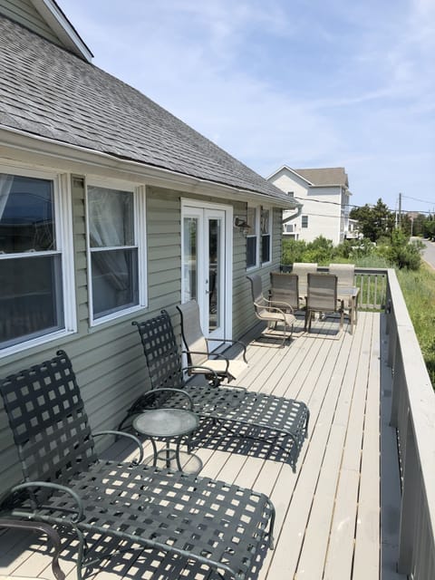 1st floor gated front deck with seating areas.