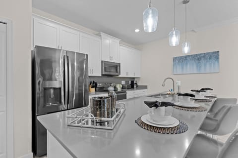 Your modern kitchen features sleek quartz countertops, stainless steel appliances, and elegant pendant lighting—perfect for preparing memorable meals.