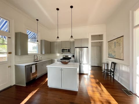 The brand new kitchen has stainless steel appliances.