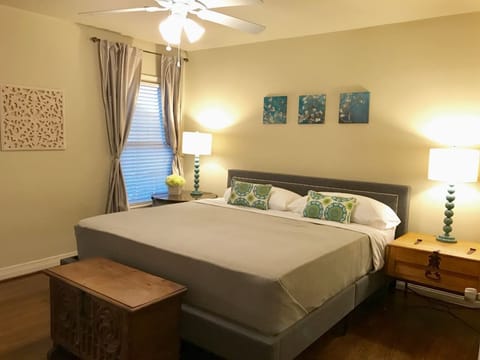 Beautifully appointed master with a new king bed, ceiling fan, closet with hangers, luggage racks and full length mirror