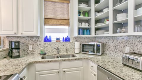 The kitchen has a microwave, coffee maker, dishwasher, and plenty of storage. 