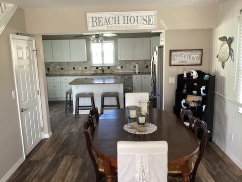 Dining and kitchen areas.  View of closet under stairs with laundry inside.
