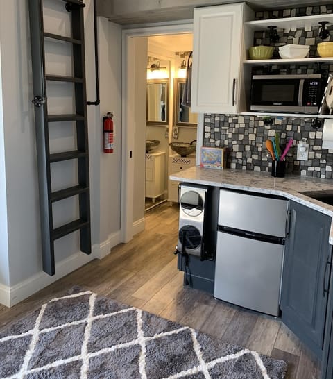 The ladder has hand railings and lifts into marked place for loft access.