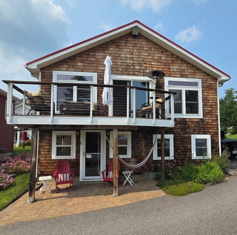 Deck upstairs with propane heater, and covered outside seating downstairs.
