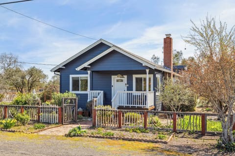 Charming blue cottage with a welcoming front porch, garden views, and cozy character—perfect for a peaceful and relaxing stay.
