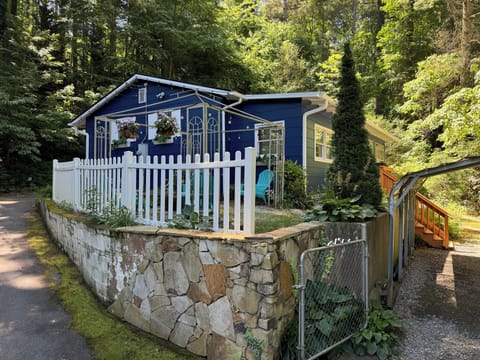 The front of the house offers a cozy fire pit and welcoming string lights.