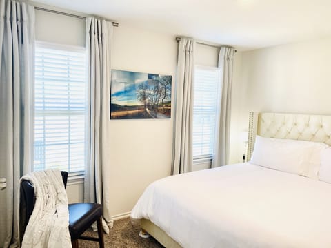 Luxurious king size bed. Wood hangers w/ darkening drapes for a satisfying sleep