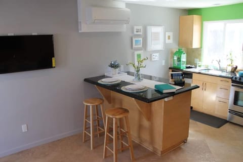 Kitchen has stainless steel appliances; dishwasher, fridge, microwave oven/stove.