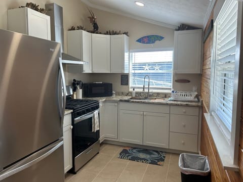 Full kitchen with gas stove, fridge, microwave, and sink