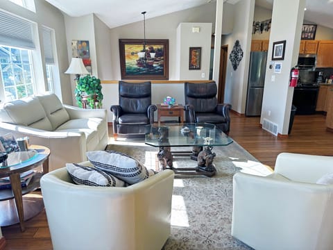 LIVING ROOM- Features vaulted ceilings, a gas Fireplace + all leather furniture