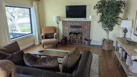 Living room with wall-mounted TV and huge picture windows.