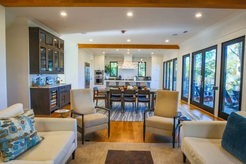 There is an open floor plan layout on the first floor between the kitchen, dining room and living room.